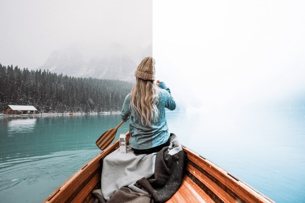 girl in a boat on a lake with winter lightroom preset from anagram design