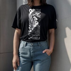 woman wearing a black t-shirt stand behind a concrete wall