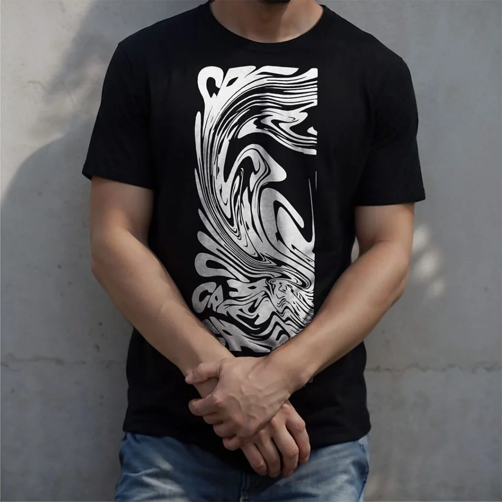 Man wearing a black t-shirt stand behind a concrete wall