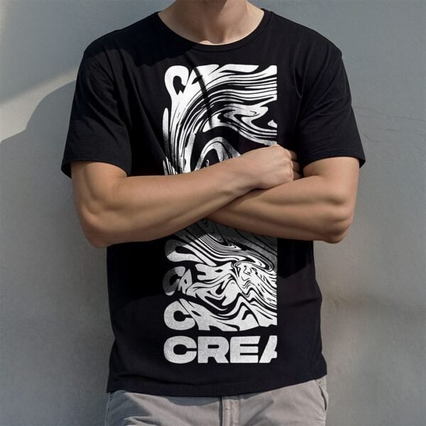 Man wearing a black t-shirt stand behind a concrete wall