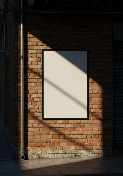 Poster on a brick wall, sunlight shadows