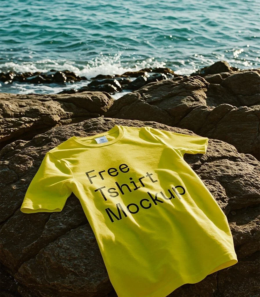 Yellow t-shirt mockup on seaside rock