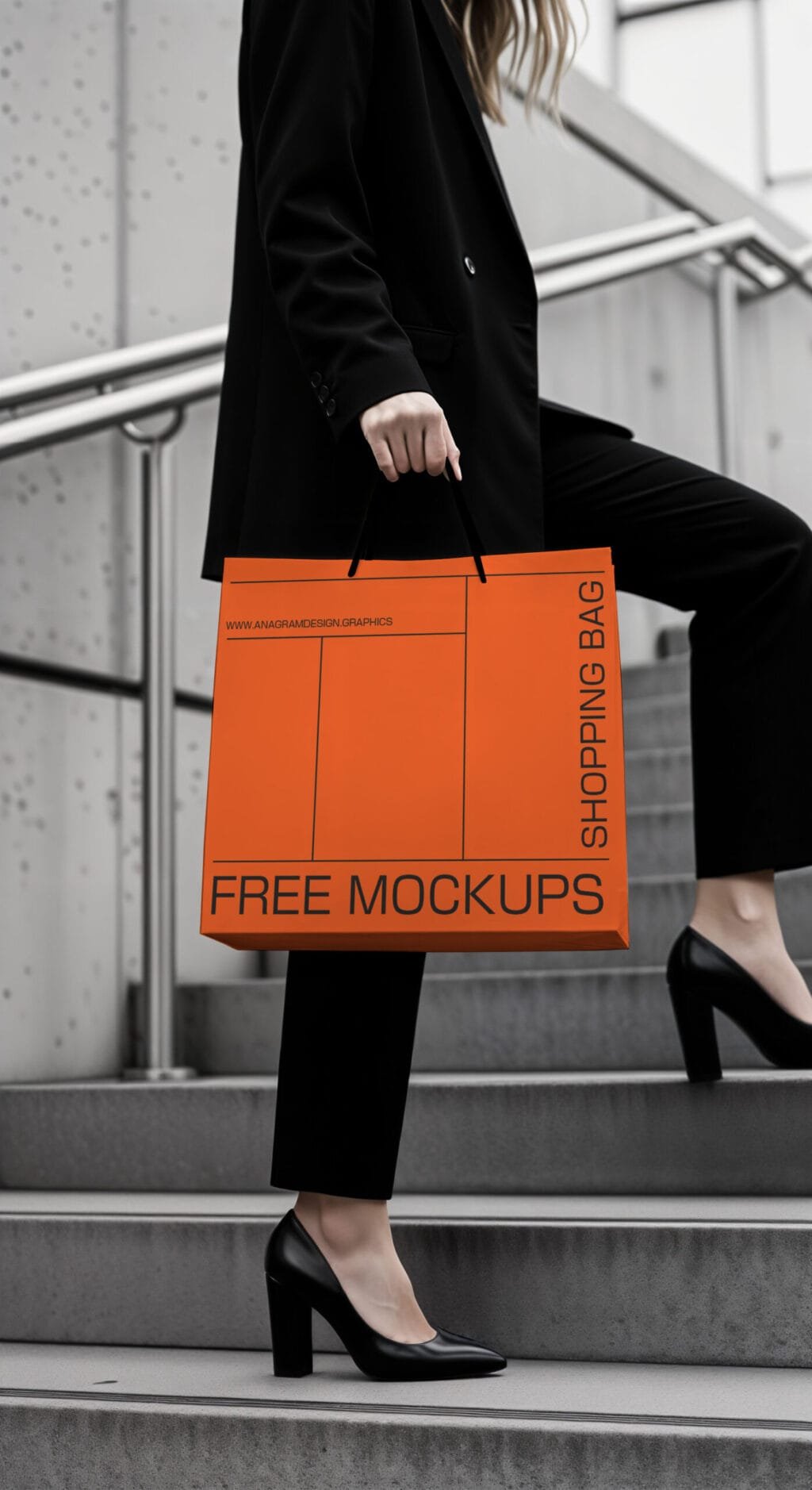 A woman in a black suit and heels holds an orange shopping bag labeled "FREE MOCKUPS" while walking up stairs