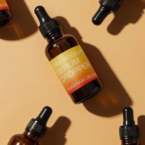 Amber glass serum dropper bottles with black caps arranged on a light beige background.