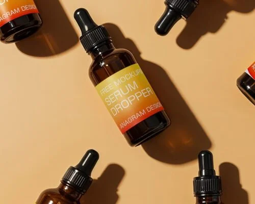 Amber glass serum dropper bottles with black caps arranged on a light beige background.