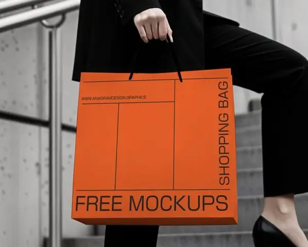 A woman in a black suit and heels holds an orange shopping bag labeled "FREE MOCKUPS" while walking up stairs