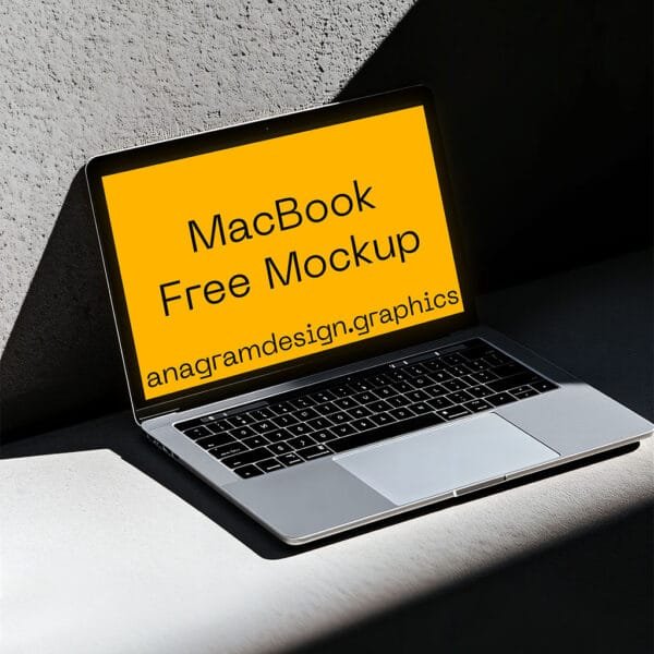 MacBook on a concret wall, har shadow light