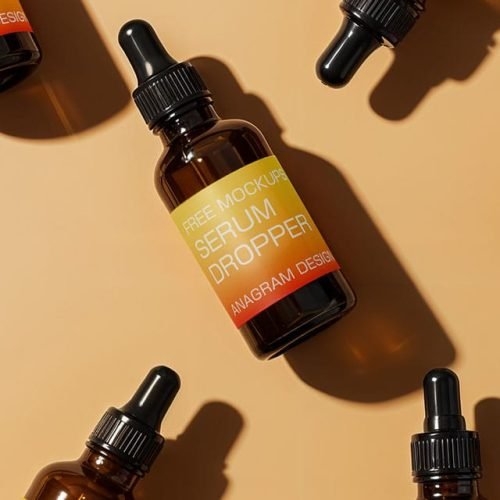 Amber glass serum dropper bottles with black caps arranged on a light beige background.